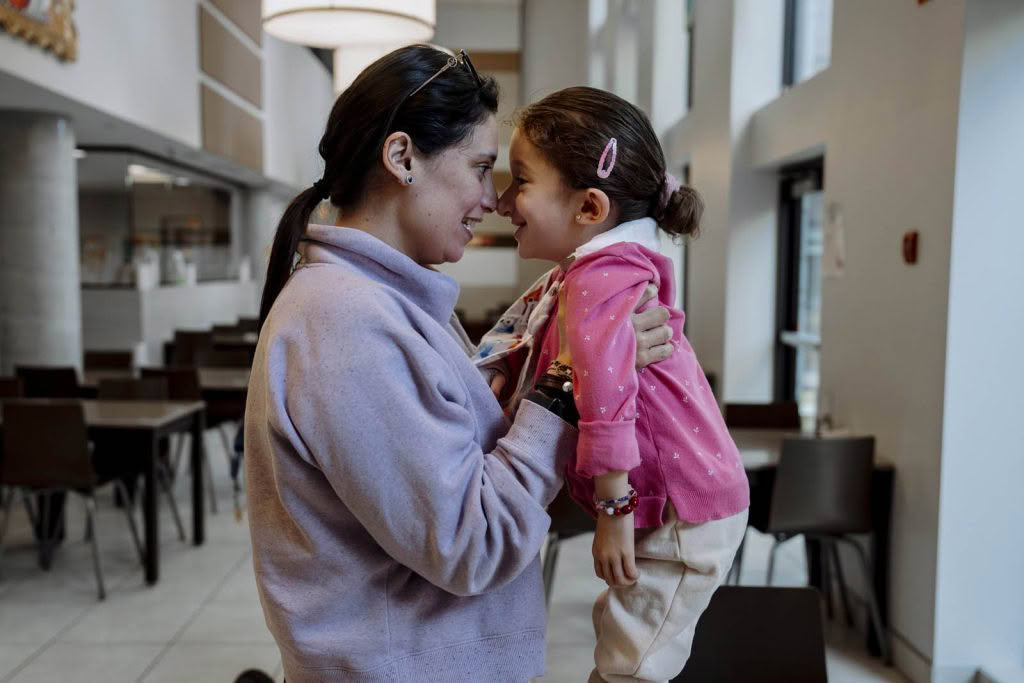 Woman carrying a smiling child