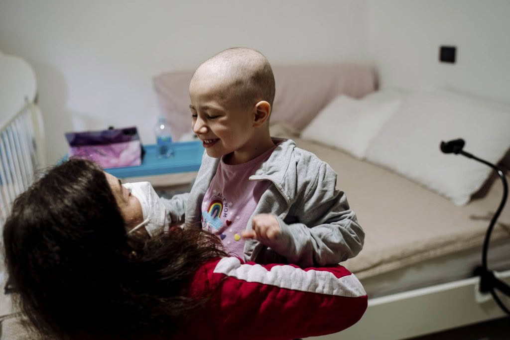 Woman carrying a smiling child